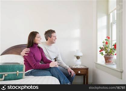 Couple sat on a bed