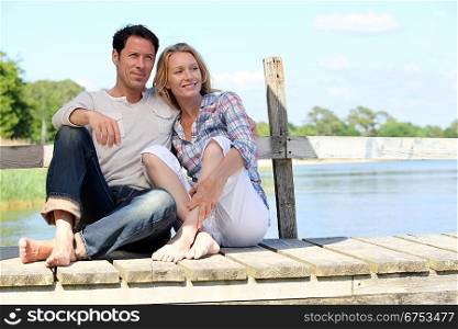 Couple sat on jetty