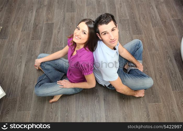 Couple sat on laminate flooring