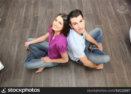 Couple sat on laminate flooring