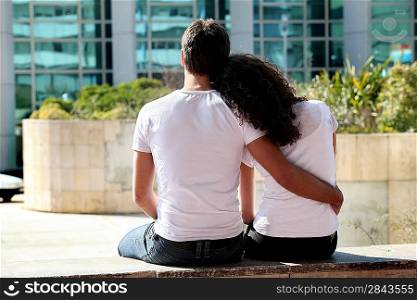 Couple sat outside modern building