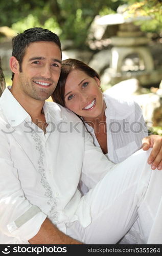 Couple sat relaxing in peaceful garden