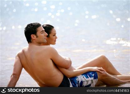 Couple sat together on a beach