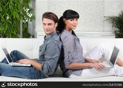 Couple sat with a laptop