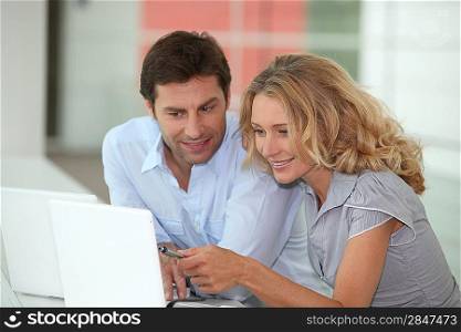 Couple sat with laptop