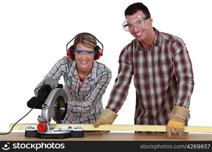 Couple sawing wood