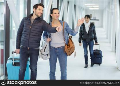 couple say hi or goodbye for abroad at airport