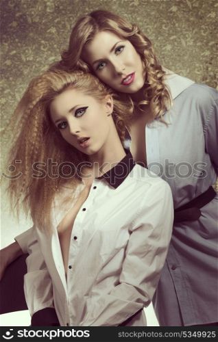 couple sexy women with fashion blonde hair-style and make-up posing and smiling, wearing sensual open shirt in vintage color