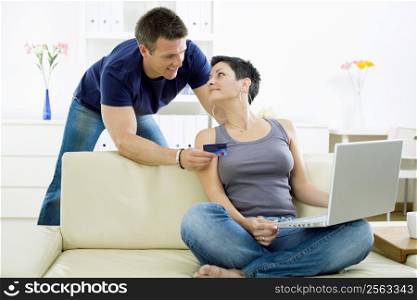 Couple shopping on internet paying by credit card.