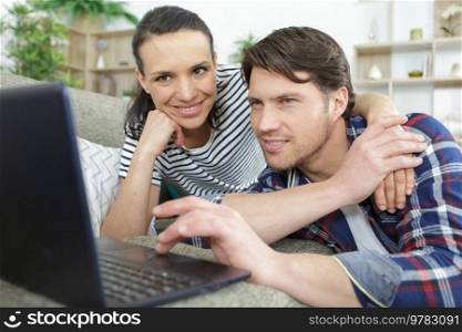 couple shopping online on the sofa in modern apartment