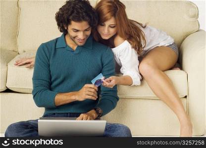 Couple shopping online with a laptop