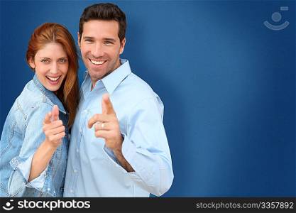 Couple showing thumbs up on blue background