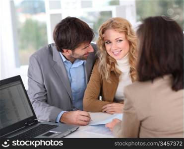 Couple signing property contract
