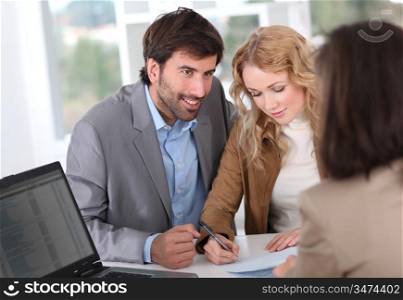 Couple signing property contract