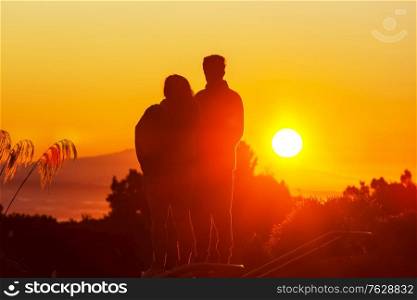 Couple silhouette on sunset background