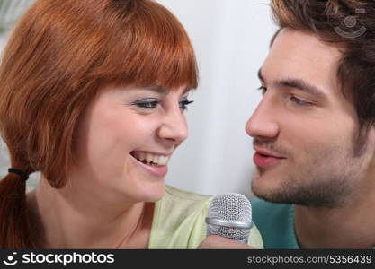 Couple singing with microphone