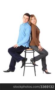 Couple sits on bar stool back to back