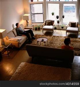 Couple sitting apart in living room
