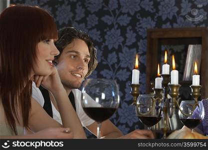 Couple sitting at dining table, close up