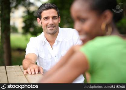 Couple sitting at rustic table