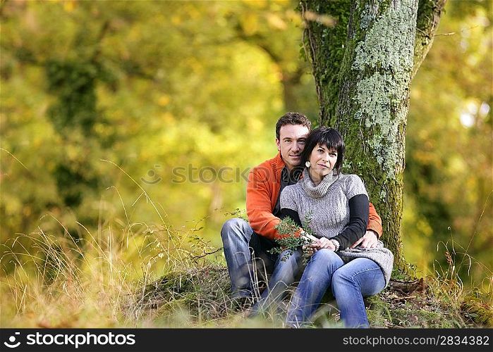 Couple sitting by a tree