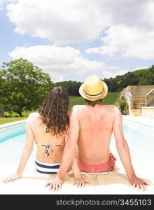 couple sitting by pool