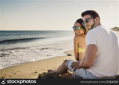 couple sitting by shoreline