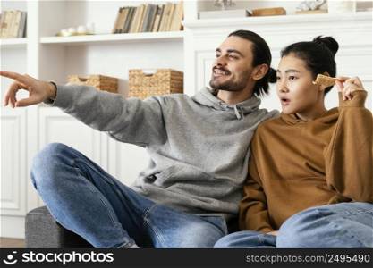 couple sitting couch watching tv 2