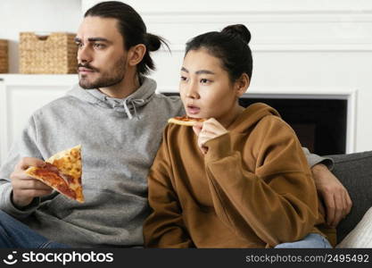 couple sitting couch watching tv