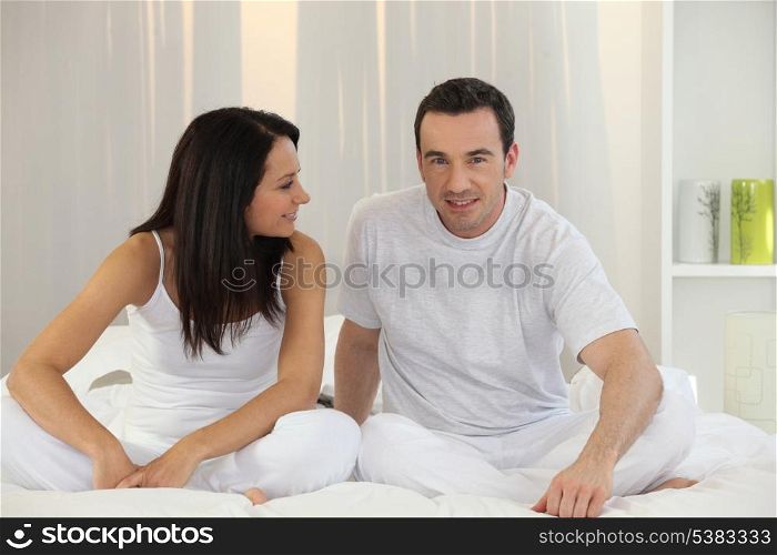 Couple sitting in bed