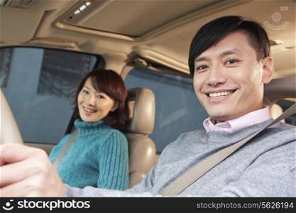Couple sitting in car, Beijing