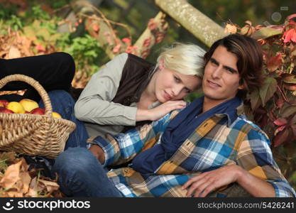 couple sitting in dead leaves