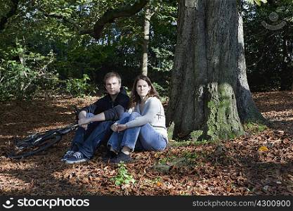 Couple sitting in forest