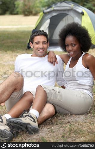Couple sitting in front of tent