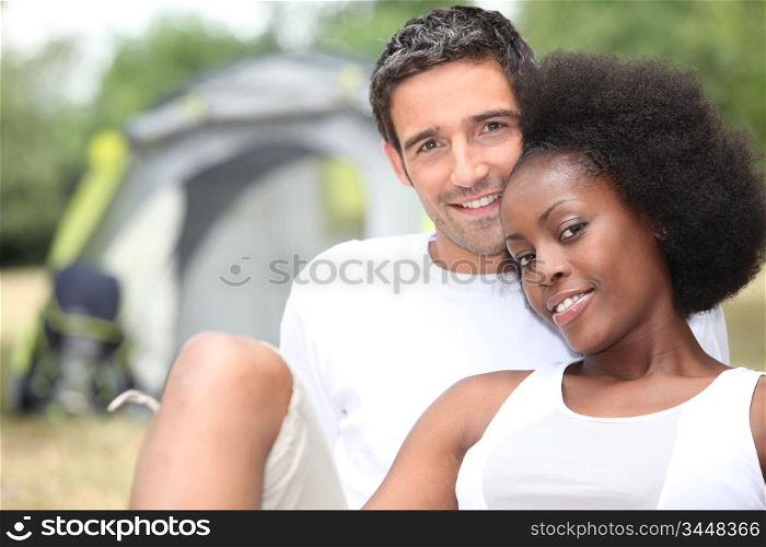 Couple sitting in front of their tent