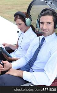Couple sitting in the cockpit of a light aircraft