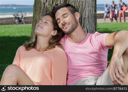 couple sitting in tree relaxing