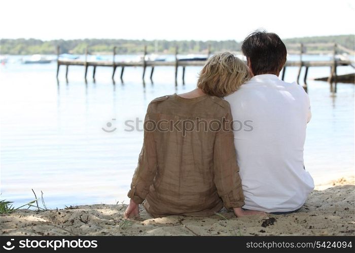 Couple sitting lakeside
