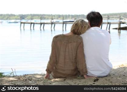 Couple sitting lakeside
