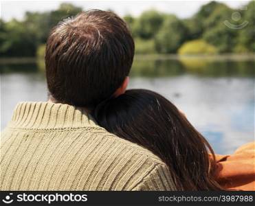Couple sitting near lake