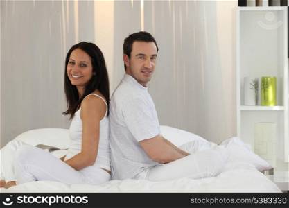 Couple sitting on a bed