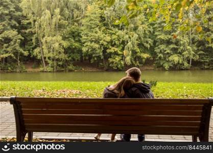 couple sitting on a bench and hugging