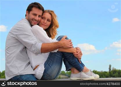 couple sitting on a wall