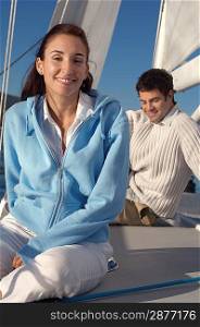 Couple Sitting on Deck of Sailboat