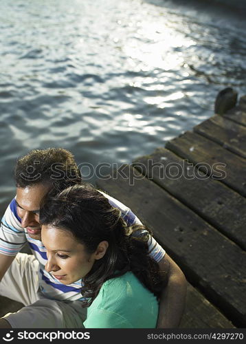 Couple sitting on dock together