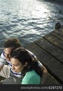 Couple sitting on dock together
