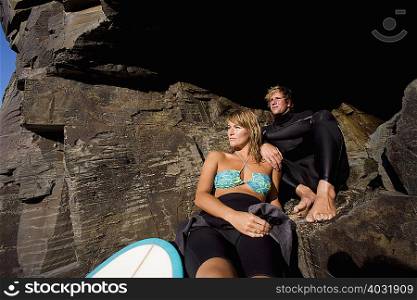 Couple sitting on large rocks