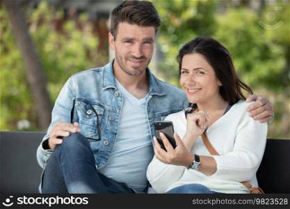 couple sitting on outdoor seat together