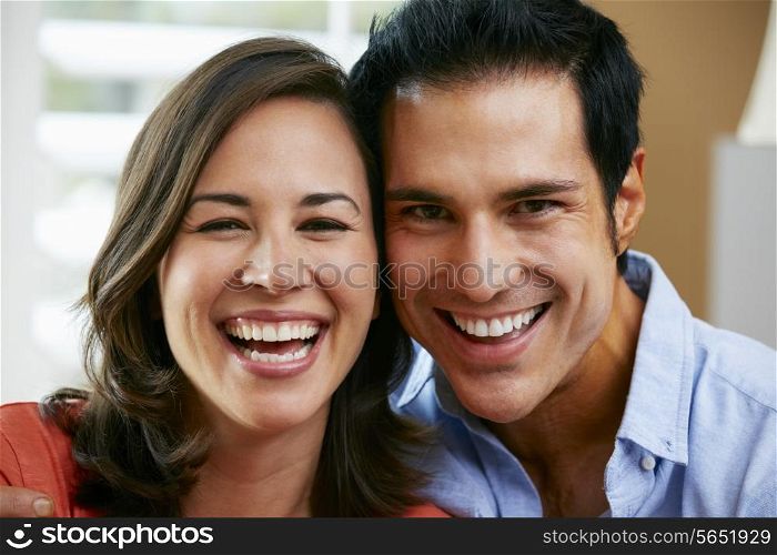 Couple Sitting On Sofa At Home Together