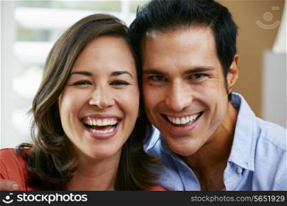 Couple Sitting On Sofa At Home Together